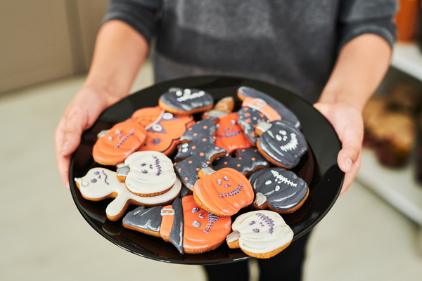 Boy Holds Plate with Various Halloween Cookies